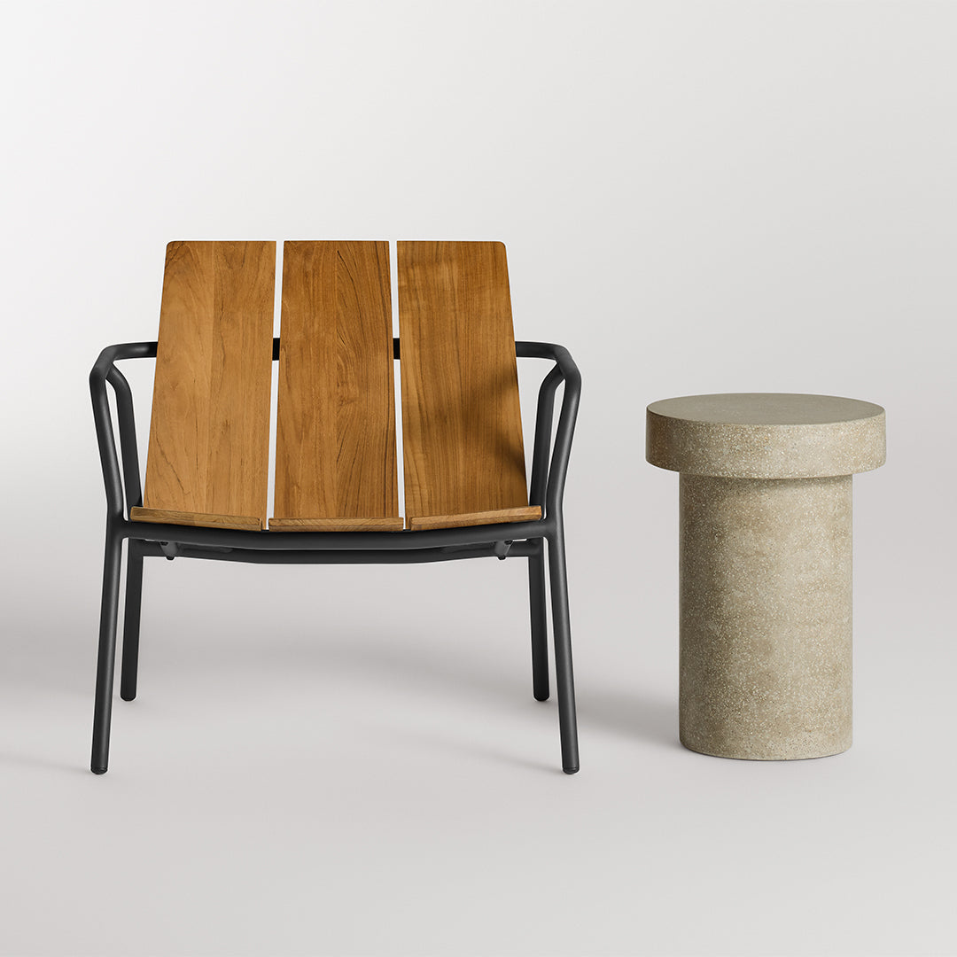 Wooden slatted chair with a natural finish, paired with a sleek gray concrete side table. Modern outdoor aesthetic.