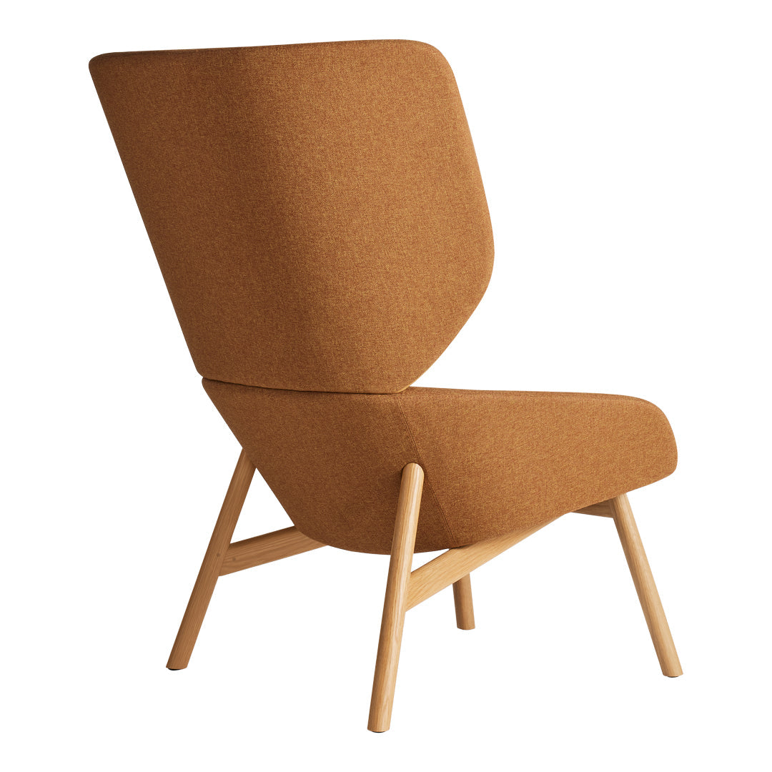 Mid-century modern chair in warm tan upholstery with a unique shaped back and light wooden legs.