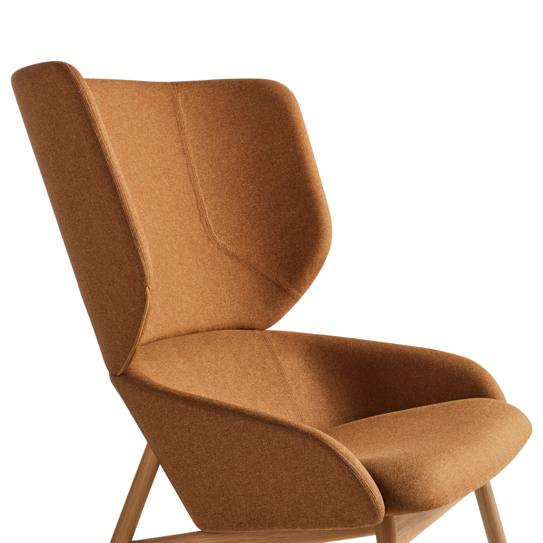 Mid-century modern chair in warm caramel brown with a smooth, textured finish and elegant contours.
