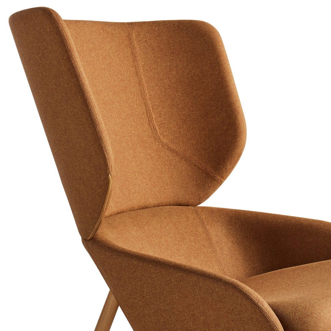 Modern chair in warm, earthy brown fabric with subtle textures and clean lines. Perfect for minimalist decor.
