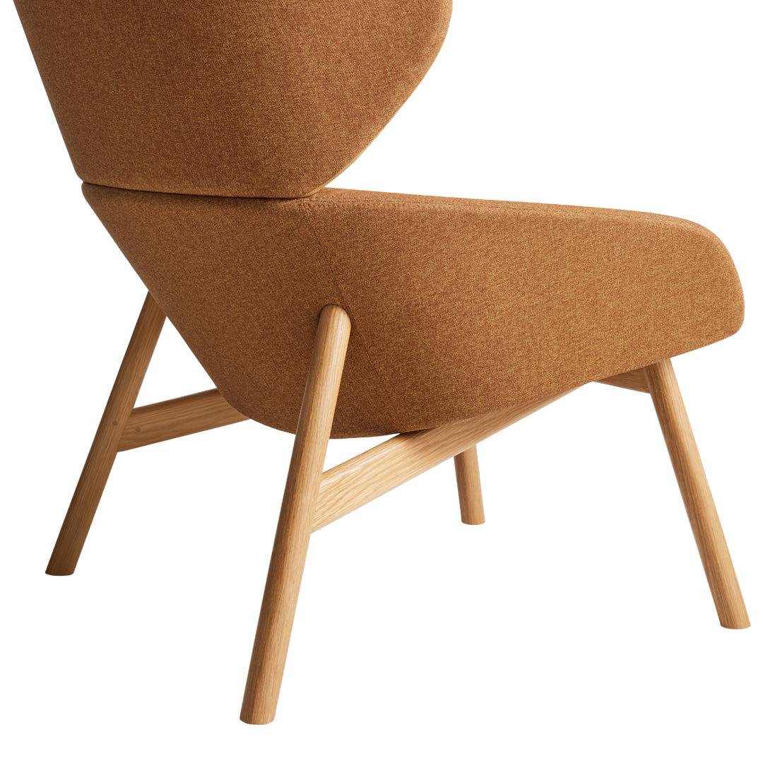 "Warm brown fabric armchair with sleek wooden legs, showcasing a modern and minimalist design."