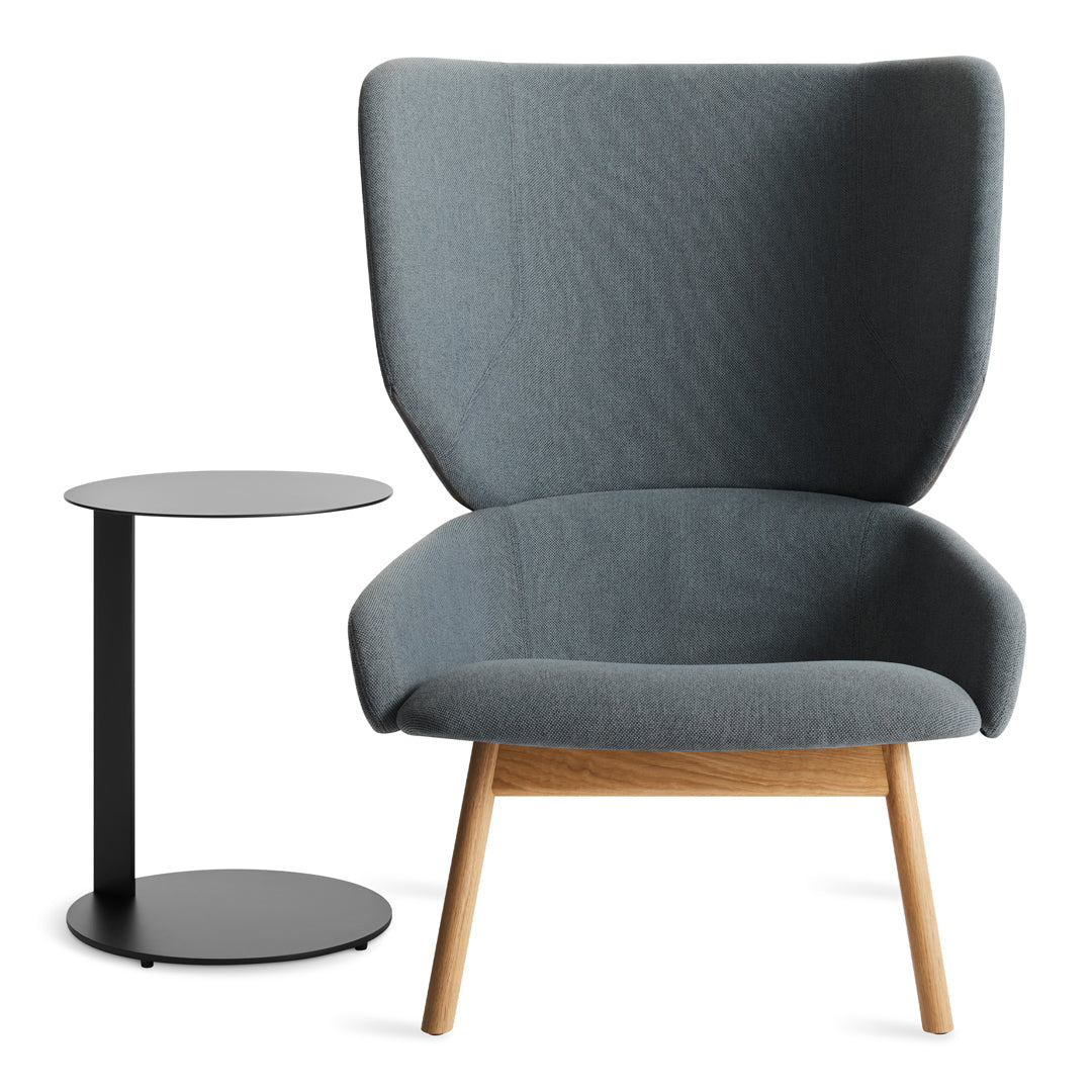 Gray upholstered chair with a textured pattern and wooden legs, paired with a sleek black side table.