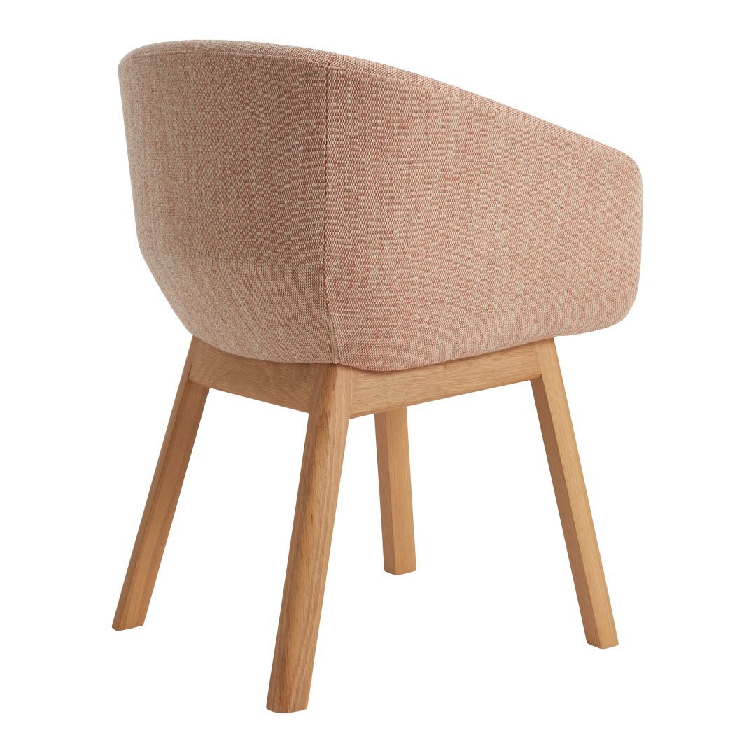 Peach-textured fabric chair with smooth wooden legs, featuring a minimalist design and contemporary style.