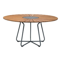 Round wooden dining table with a natural wood finish, featuring a geometric pattern and a black metal base.