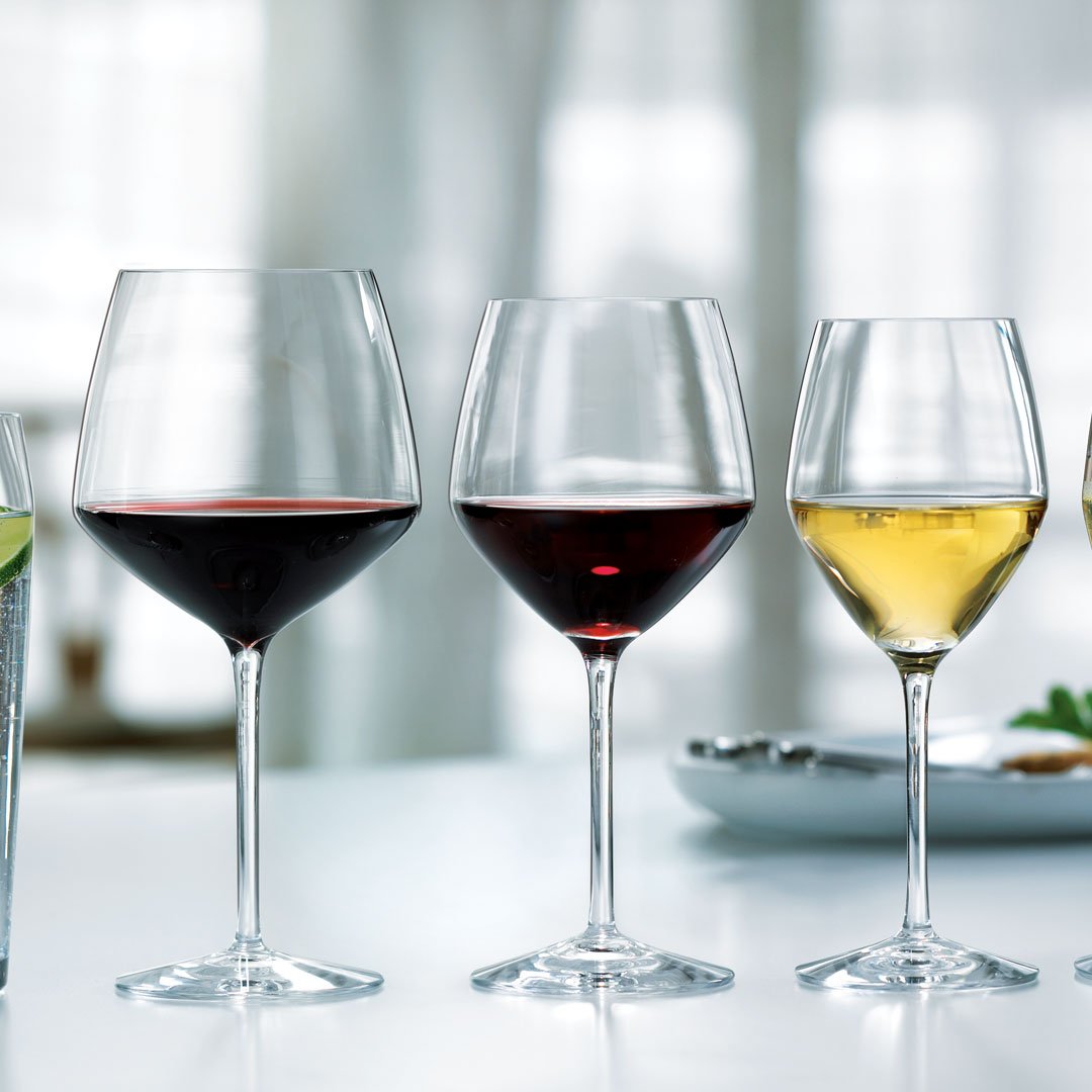 Elegant glassware showcasing a gradient of colors: clear, deep red, and golden hues, perfect for wine enthusiasts.