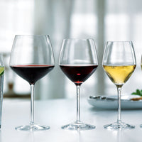 Elegant glassware showcasing a gradient of colors: clear, deep red, and golden hues, perfect for wine enthusiasts.