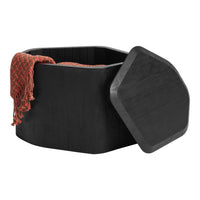 Black hexagonal storage box with a textured orange blanket draped over the side. Simple and modern design.