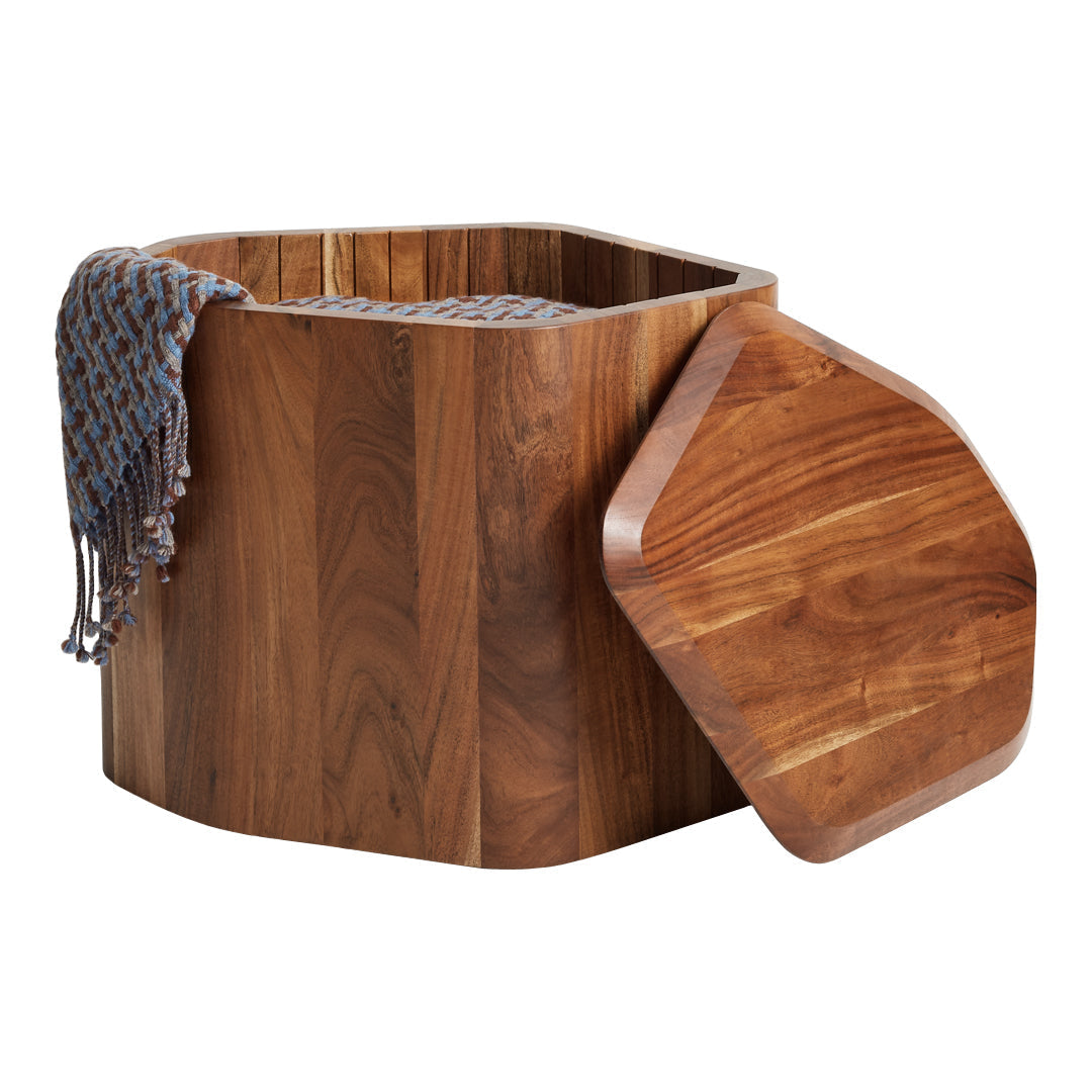 Hexagonal wooden storage bin with rich brown tones, featuring a textured blue and gray patterned throw draped over the side.
