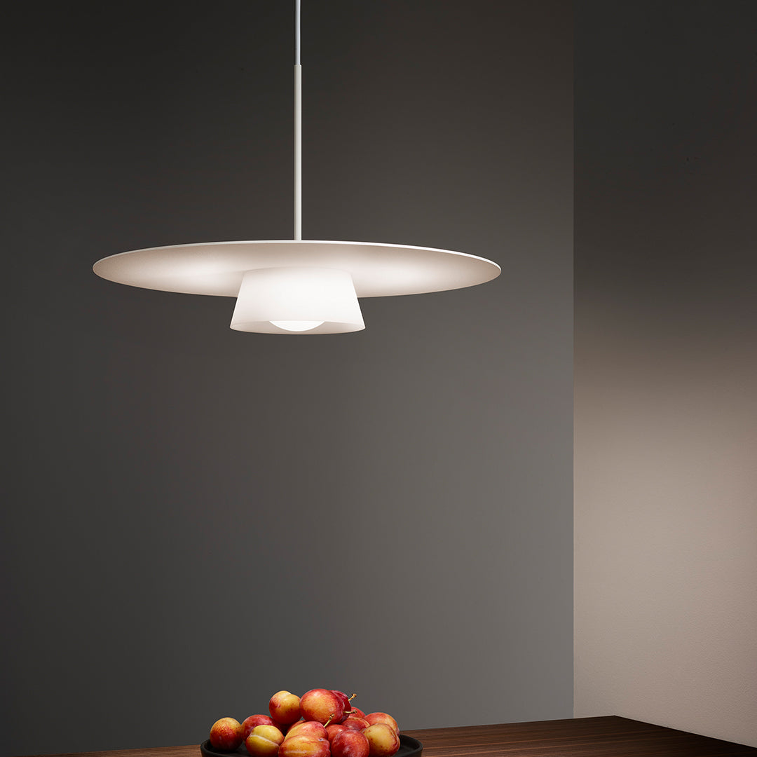 Stylish white pendant lamp with sleek, modern design, casting soft light in a minimalistic, dark gray space.