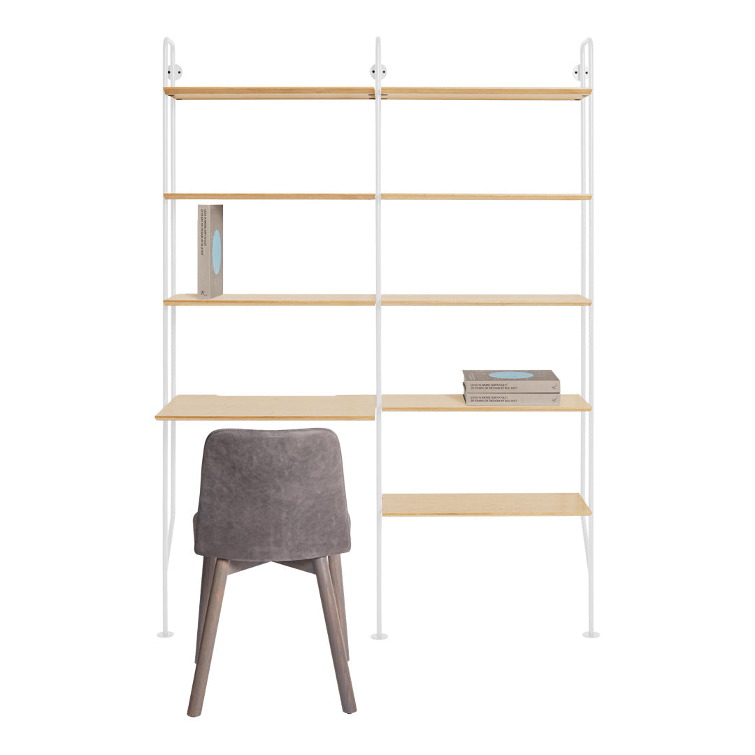 Modern white shelving unit with natural wood shelves and a gray upholstered chair. Minimalist design with sleek lines.