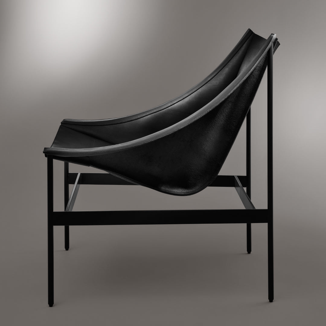 Black leather chair on a sleek black metal frame, showcasing a minimalist design and smooth curves.