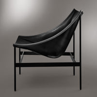 Black leather chair on a sleek black metal frame, showcasing a minimalist design and smooth curves.