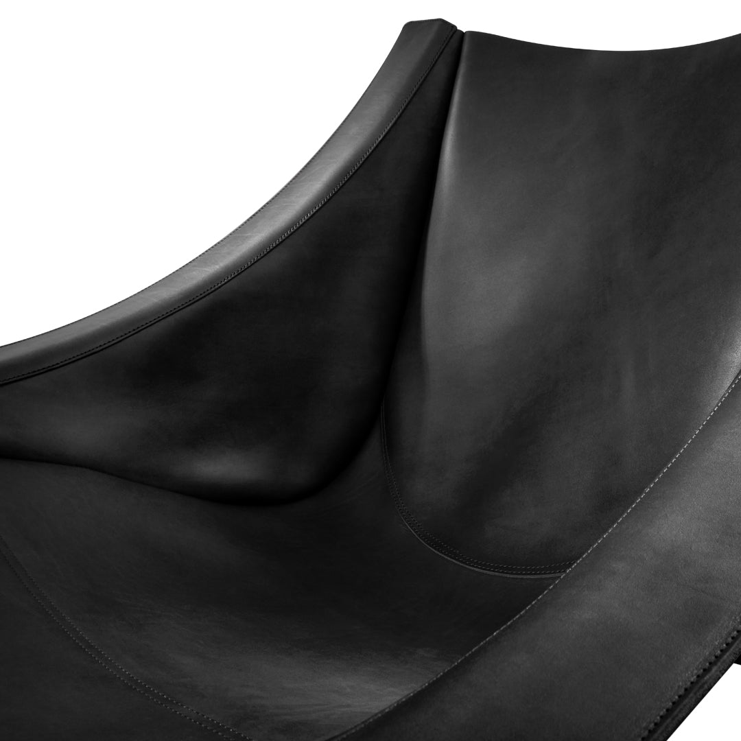 Black leather chair with smooth texture and sleek, modern design. Perfect for contemporary decor.