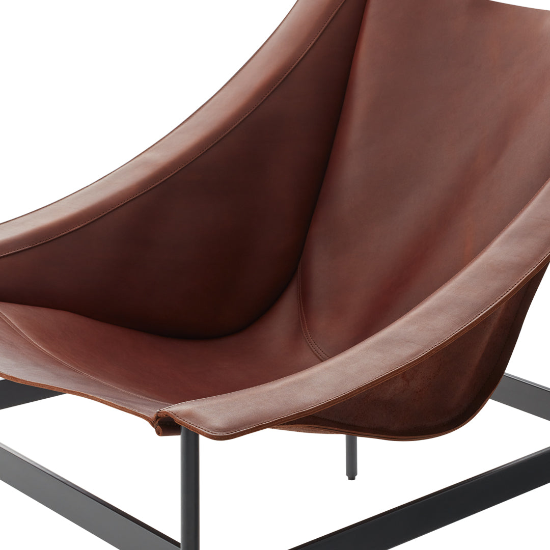 Brown leather lounge chair with a smooth, curved design and a minimalistic black metal frame. Perfect for modern decor.