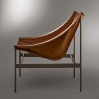 Brown leather sling chair on a sleek metal frame, featuring smooth curves and a minimalist design.