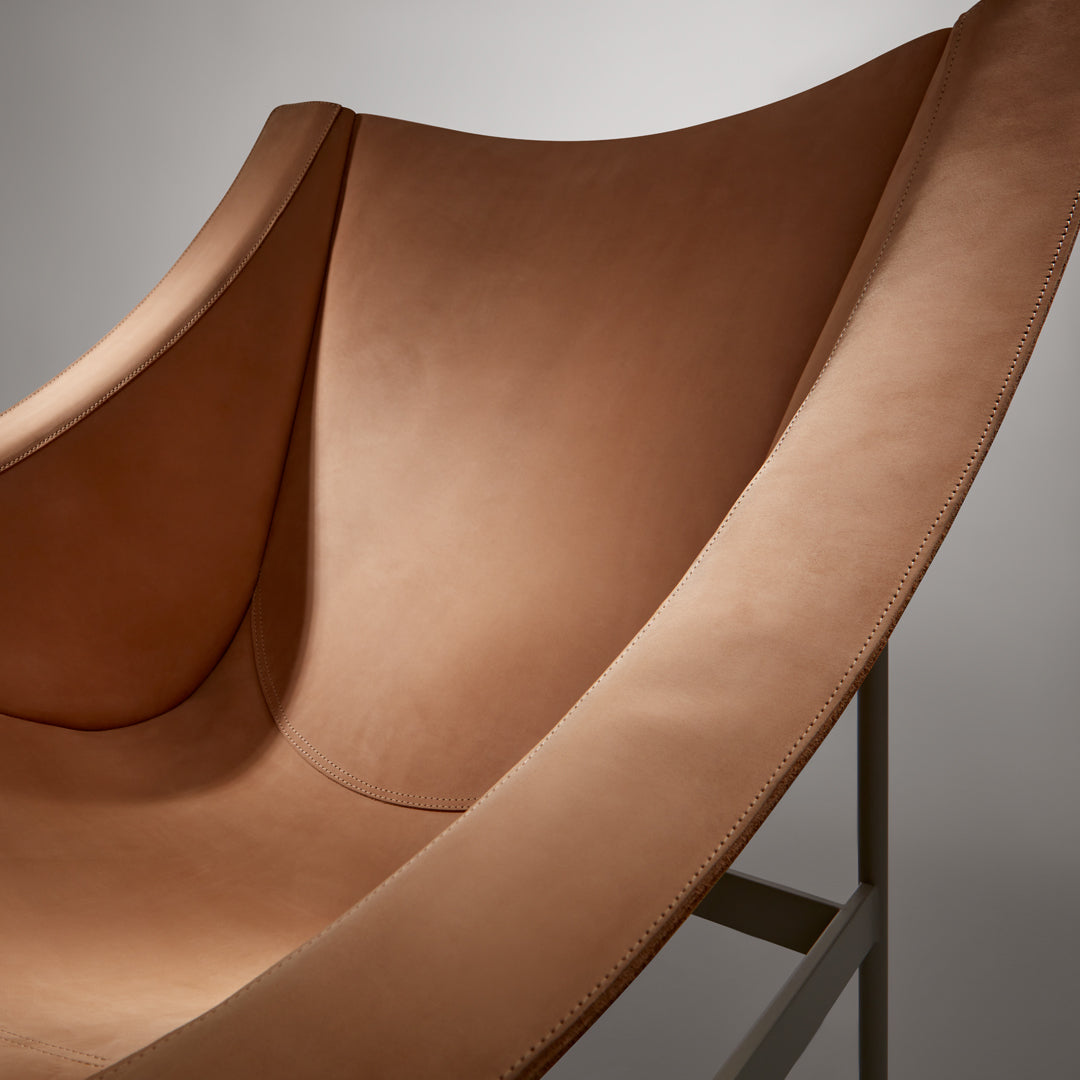 Soft, smooth brown fabric with a sleek, modern design and subtle curves. Perfect for contemporary decor.