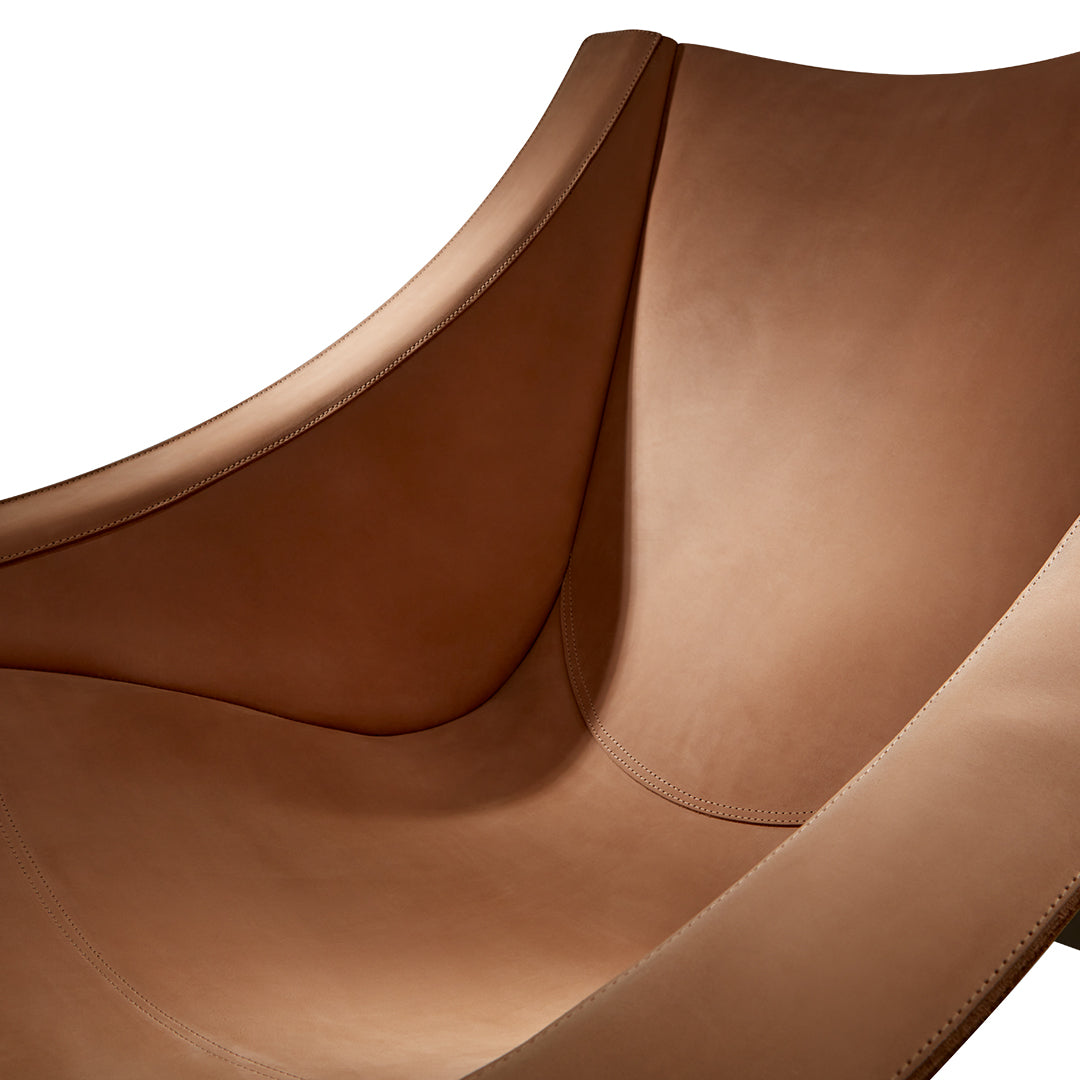 Sleek, curved design in rich caramel brown leather with a smooth, matte finish. Perfect for modern interiors.