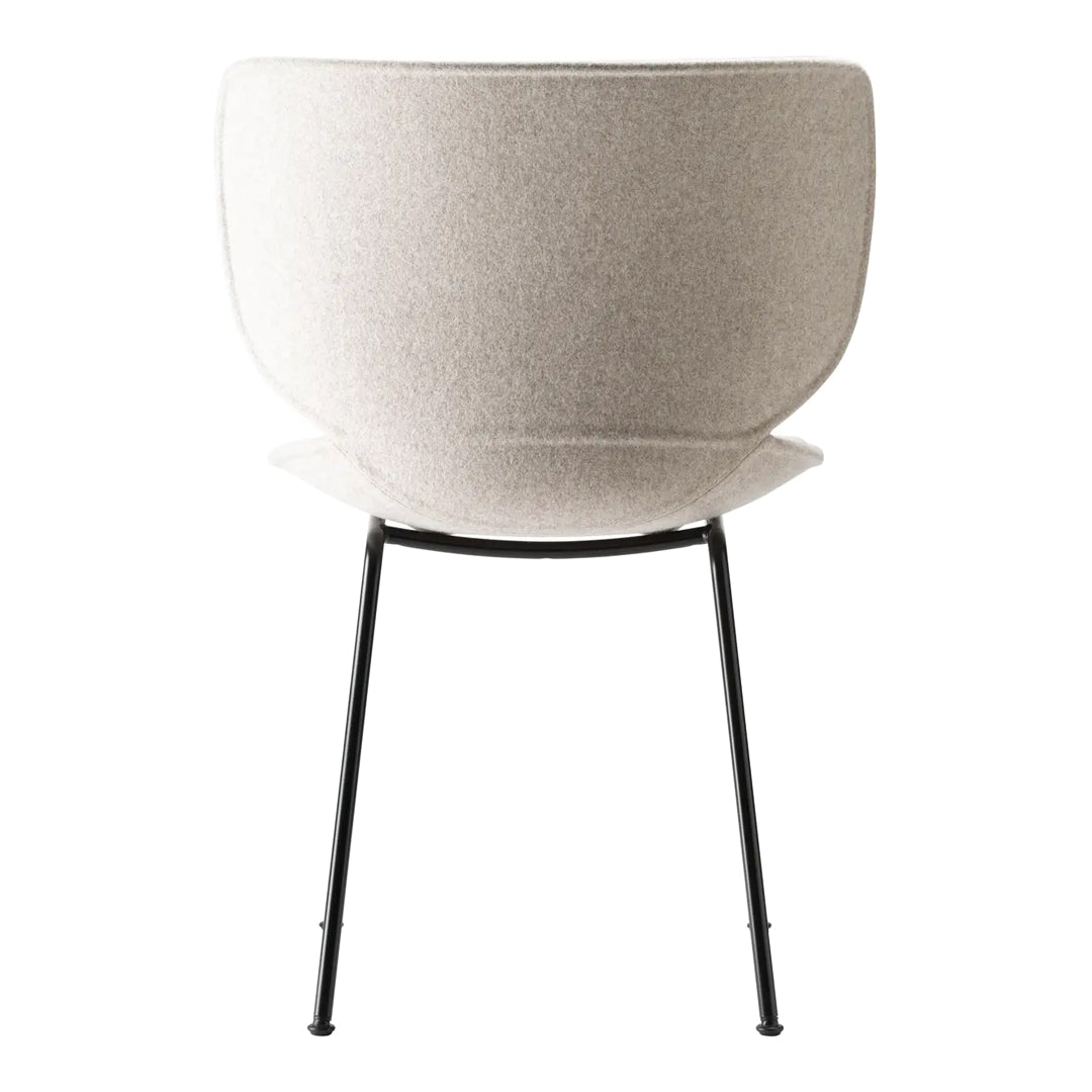 Light grey upholstered chair with smooth finish and minimalist black metal legs. Modern, sleek design.