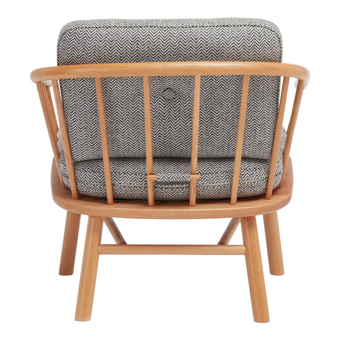 Gray woven fabric armchair with a natural wood frame, featuring a modern, minimalist design.