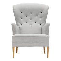 Light gray upholstered chair with tufted back and wooden legs, featuring a sleek, modern design.