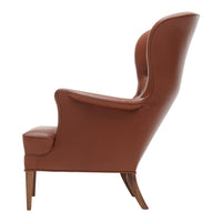 Brown leather armchair with a smooth finish and minimalist design, featuring natural wooden legs.