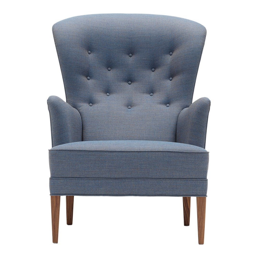 Light blue tufted accent chair with sleek wooden legs and a modern silhouette, perfect for stylish interiors.