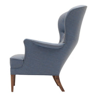 Blue upholstered armchair with a sleek, modern design and dark wood legs, featuring a textured, subtle pattern.