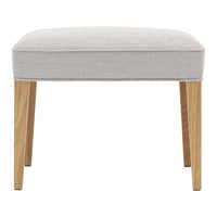 Light gray upholstered stool with natural wood legs, featuring a smooth, minimalist design. Ideal for modern decor.