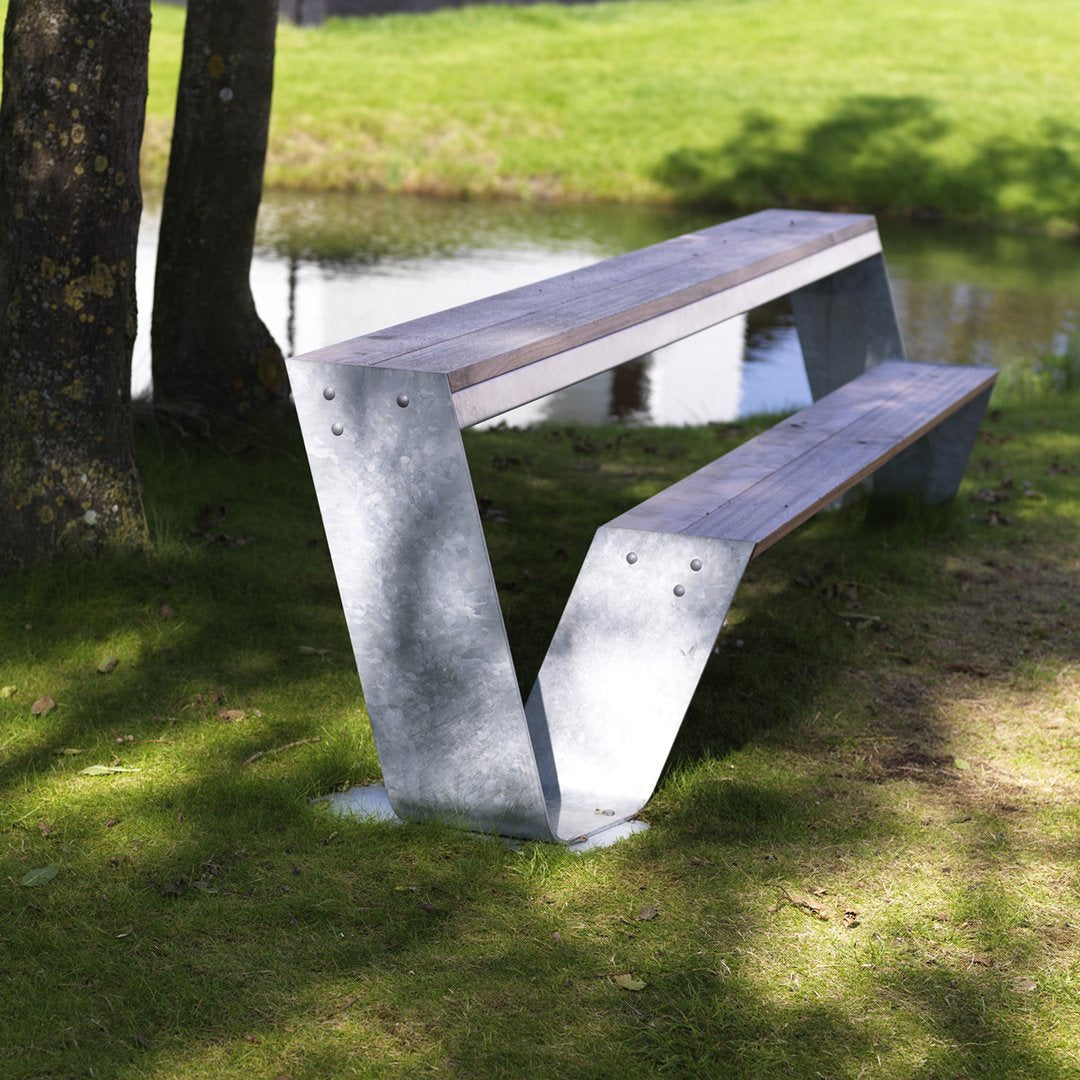 Galvanized steel bench with wooden seating, featuring a sleek geometric design and natural outdoor setting.