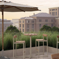 "Outdoor bar set with beige and natural wood tones, featuring a striped umbrella in soft cream and tan."