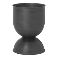Matte black planter with a smooth, rounded shape and a unique hourglass base design. Perfect for modern decor.