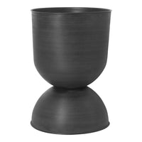 Matte black hourglass-shaped planter with smooth texture and modern minimalist design.