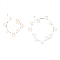 Two hanging circular decorations featuring soft pastel colors and iridescent bubble patterns on silver frames.