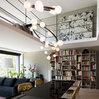 Modern chandelier with a sleek black frame and round white glass bulbs, set against a neutral-toned interior with bookshelves.