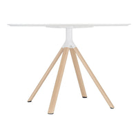 Modern white round table with natural wooden legs, featuring a minimalist design and clean lines.
