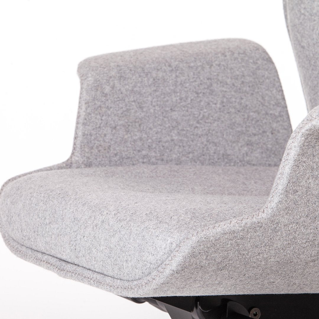 Gray upholstered chair with a smooth, textured fabric and minimalist design. Perfect for modern decor.