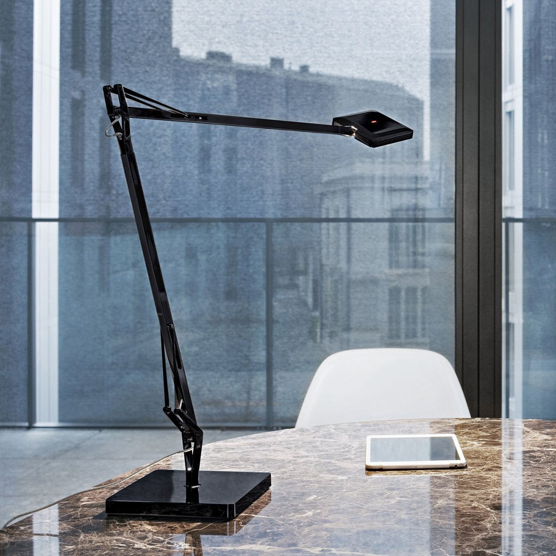 Sleek black desk lamp with a modern design, featuring a matte finish and geometric patterns on the base.
