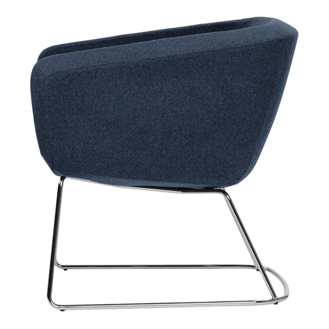 "Modern dark blue upholstered chair with a sleek chrome base, showcasing a minimalist design."