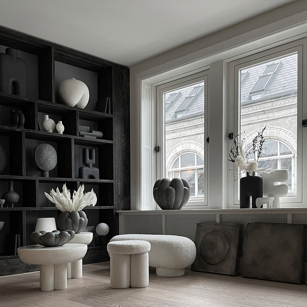 "Monochrome decor featuring black, white, and gray geometric shapes and textures in a modern interior setting."