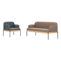 Two modern upholstered sofas: one in dark gray and one in light brown, both with sleek black legs and wooden accents.
