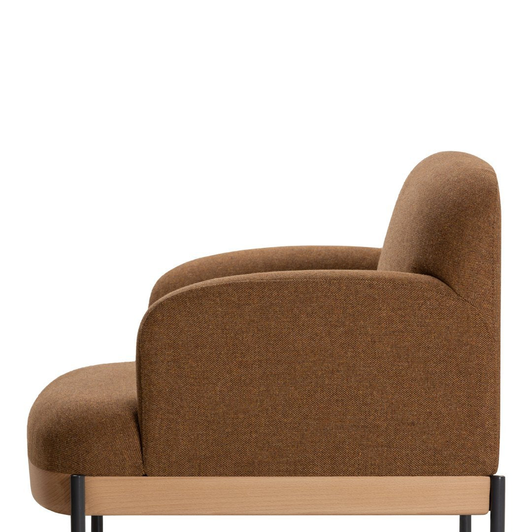 Brown upholstered chair with a smooth, curved design and minimalist black metal legs.