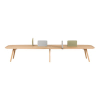 Scandinavian-style wooden table in natural wood finish with muted green and gray decorative accents.