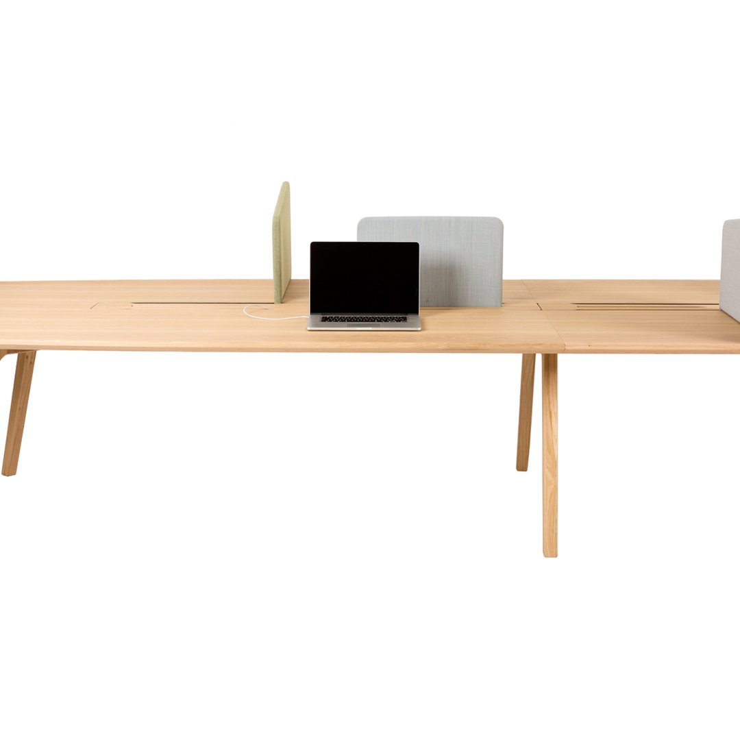 Light wood desk with a smooth surface, featuring minimalist gray and green accents. Modern design for a stylish workspace.