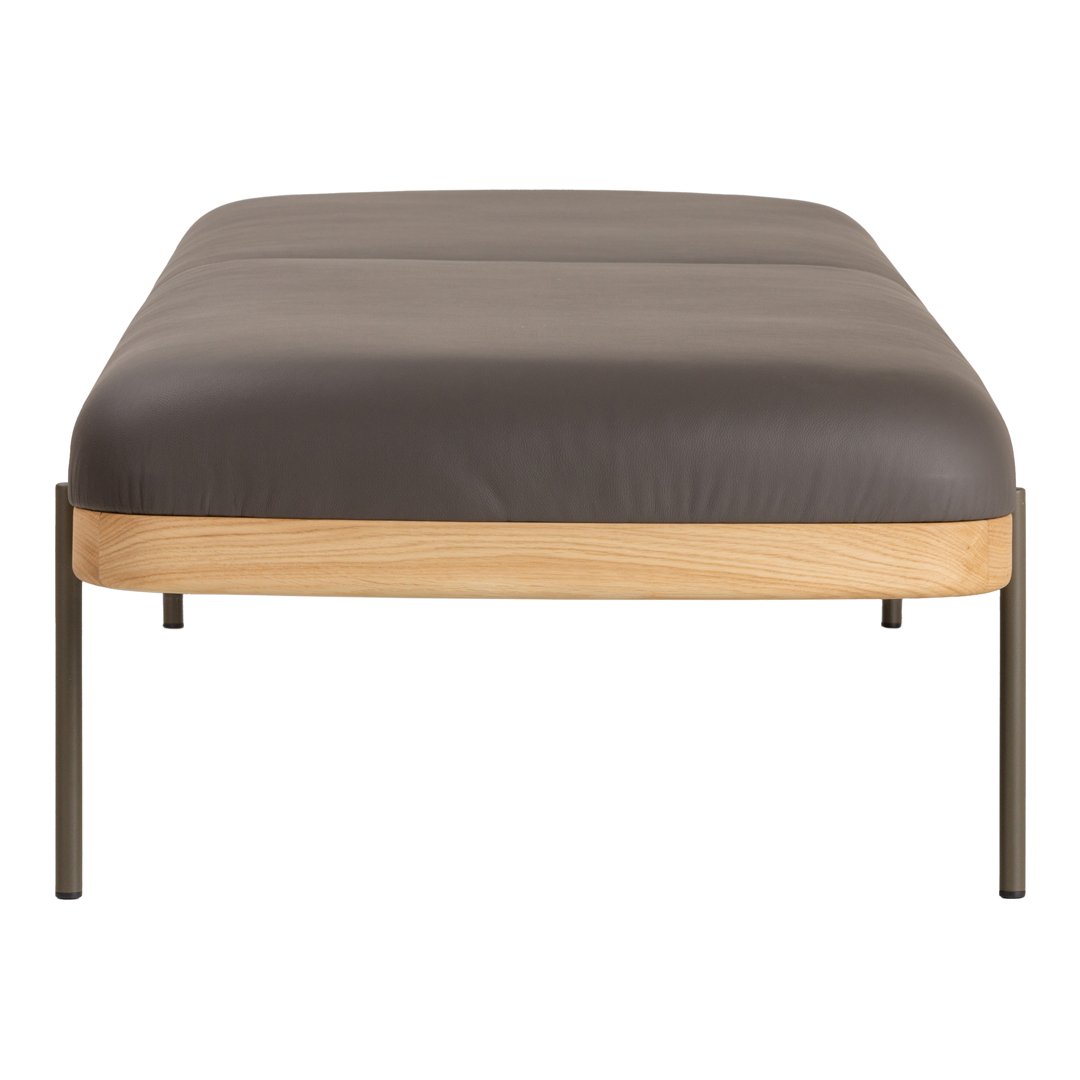 Modern bed with a dark gray mattress and light wooden base, featuring sleek metal legs for a contemporary look.