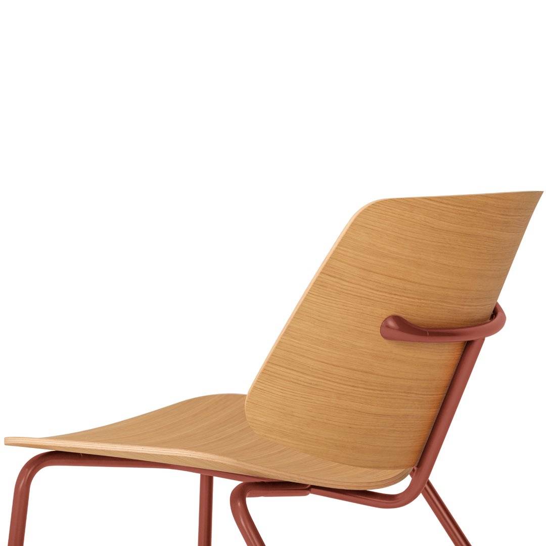 Side view of a blue velvet chair with a rich wooden frame, surrounded by natural wood textures.