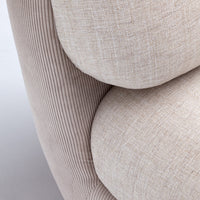 Beige textured upholstery with subtle ribbed and woven patterns, creating a cozy and inviting look.