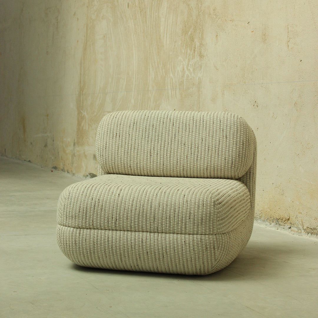 Beige striped upholstered chair with a textured pattern, featuring soft curves and a modern design.