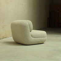 Textured light beige chair with vertical ribbed pattern, perfect for modern and minimalist decor.