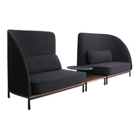 Modern black upholstered sofa with rounded edges and a contrasting wood accent table, showcasing sleek lines and textures.