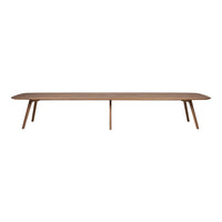 Long, minimalist coffee table in warm brown wood with smooth surface and tapered legs, perfect for modern decor.